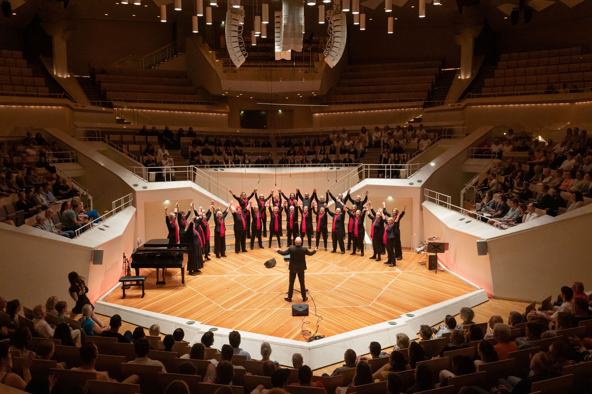 Next Stage Choir and Russell Scott celebrating a performance at the Berlin Philharmonie